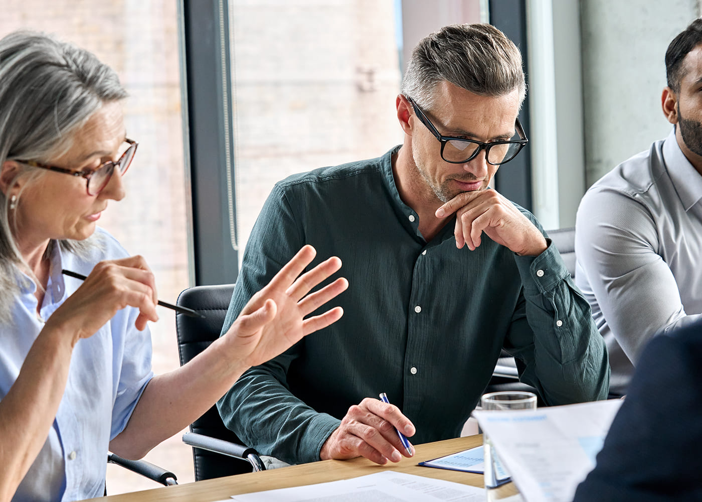 Strategic Growth - Man discusses company growth strategy with colleagues