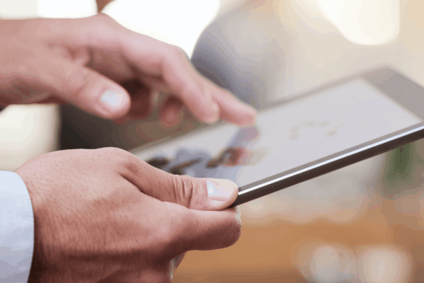 SEO-friendly web design - Man browsing website using a tablet